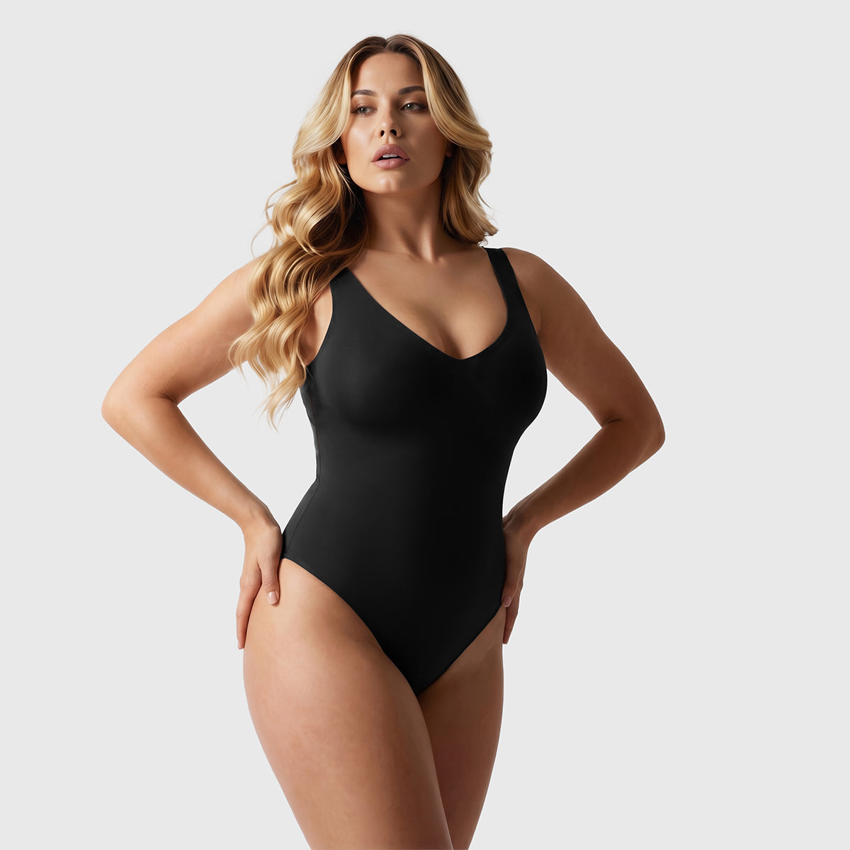 Shevee unlined plunge thong Bodysuit black front view hands on waist sculpting